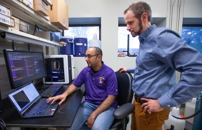 Sakib Ferdous and Nigel Reuel examin computer simulations of cell cultures.